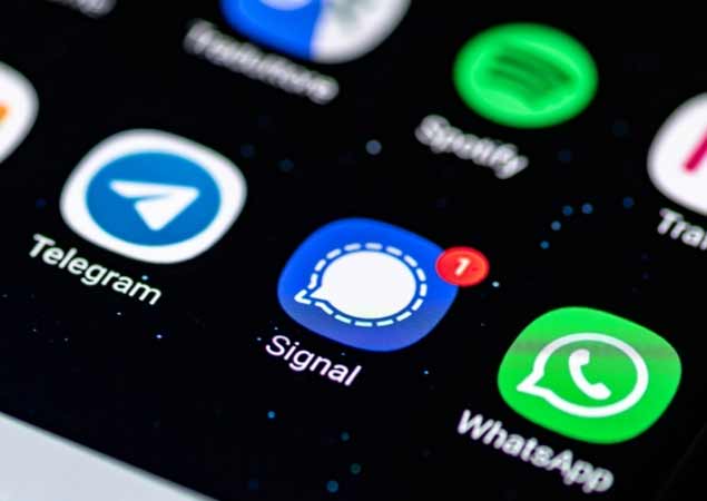 Signal app, a cross-platform encrypted messaging service developed by the Signal Foundation and Messenger, displayed on a smartphone with Whatsapp and Telegram.
